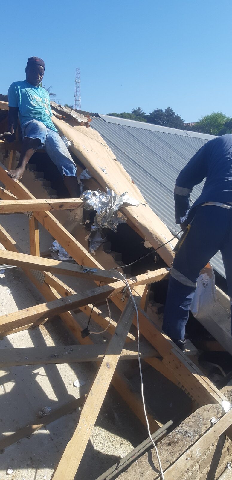 Worker on tile roof